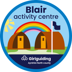 Badge for the Blair Acvtivity Centre, showing simple graphics of the wigwams with flag with a rainbow and sun